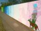 alt view of colorful mural painted onto 500' fence