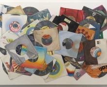 a watercolor painting of a messed up pile of 45 records