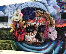 colorful mural with Day of the Dead skeleton imagery