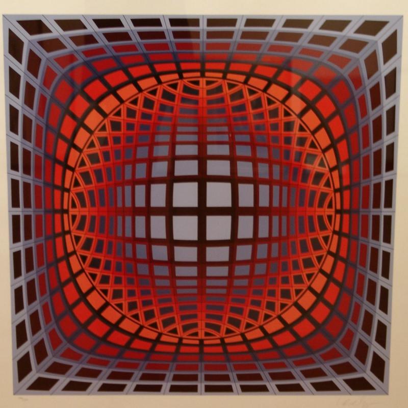 Optical art painting featuring a grid of red, orange, and purple squares that curve inward toward the center, creating the illusion of a spherical form receding into space. The geometric pattern produces a dynamic sense of depth and movement, characteristic of Victor Vasarely’s op art style